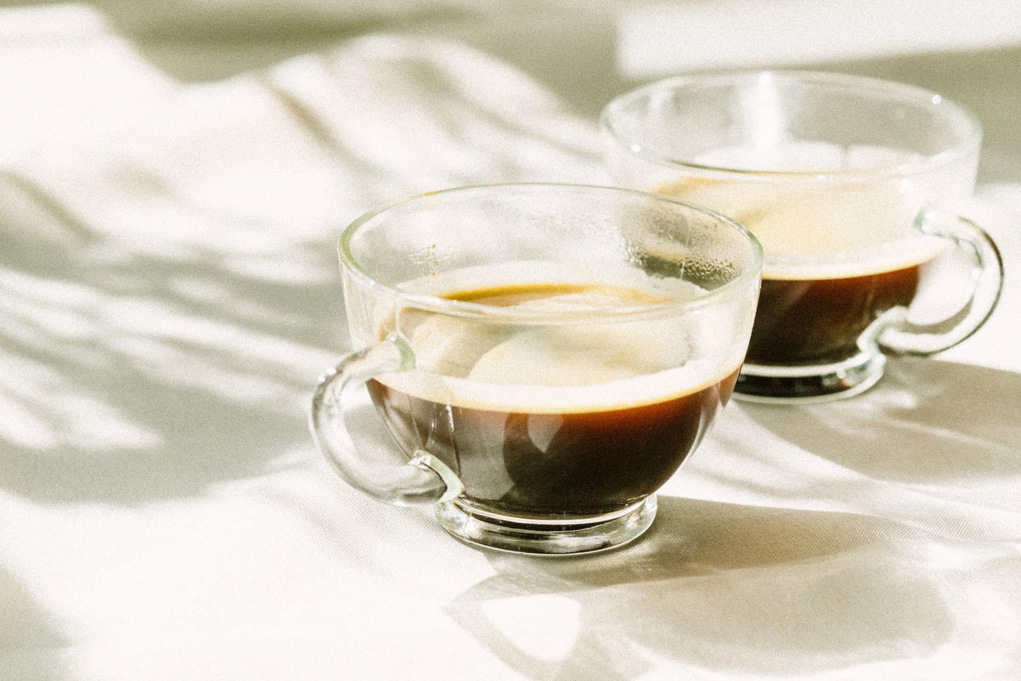 Two glass cups of coffee in soft light