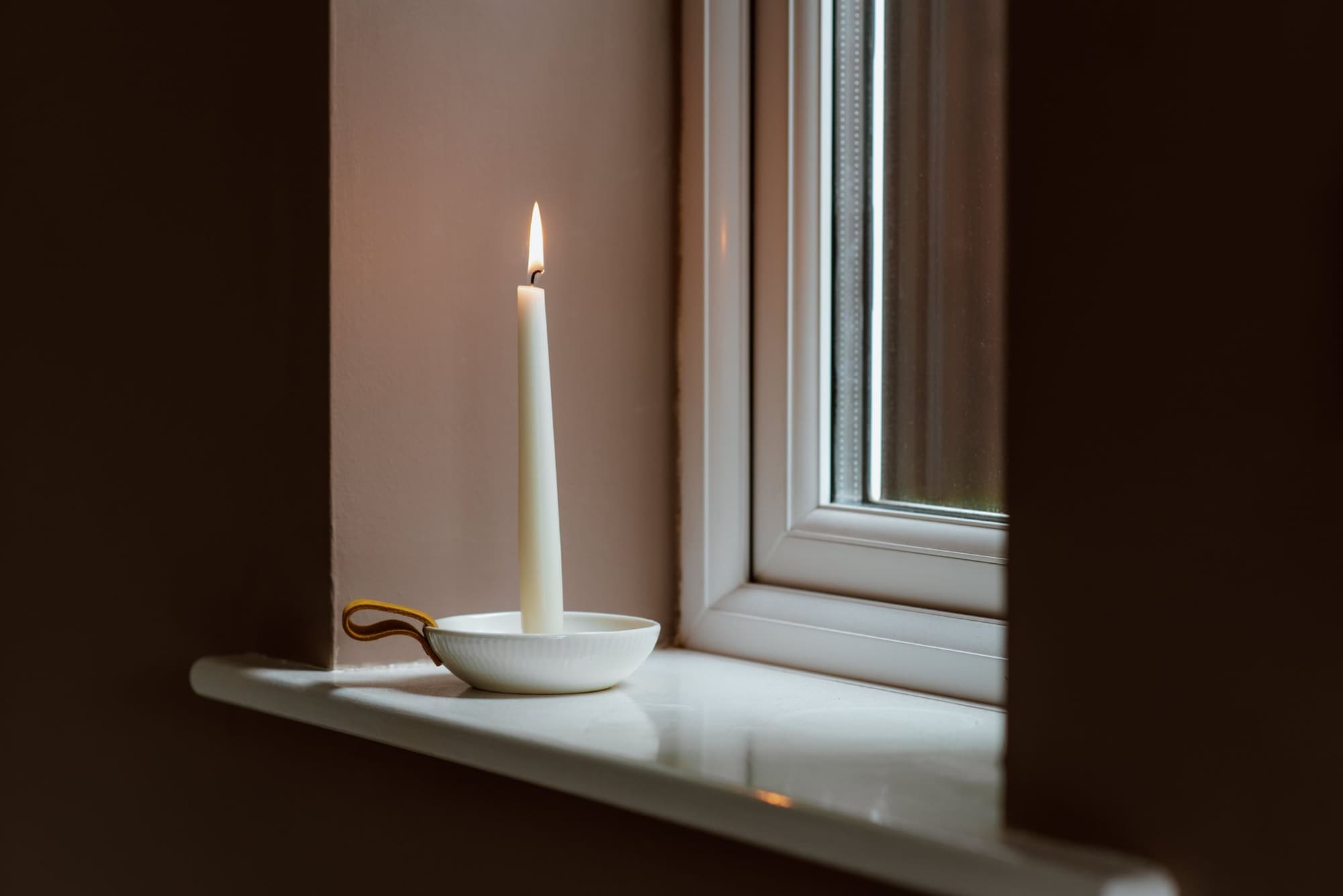 A candle on a windowsill